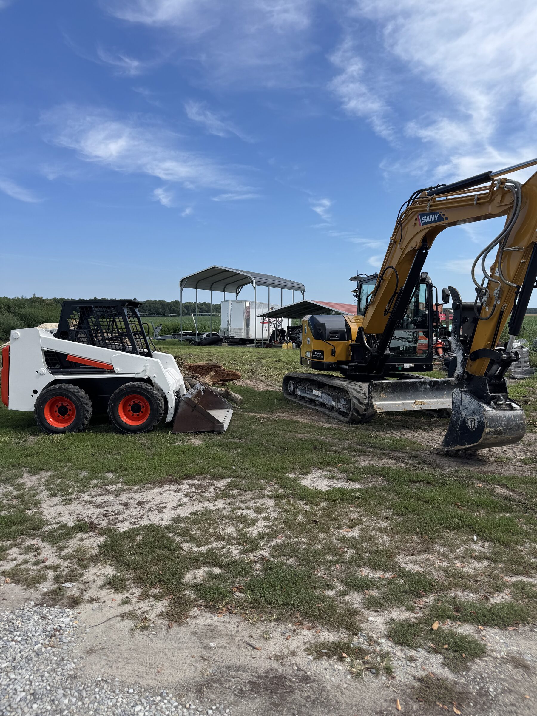 Bobcat skid steer and tracked excavator parked at Marshy Hope Construction in Rhodesdale, Maryland